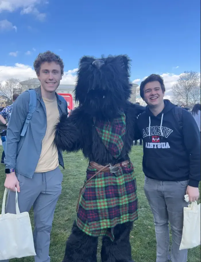 students posing with the scotty mascot